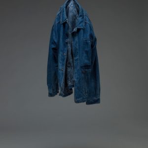 Home Denim jacket photographed against a plain dark background
