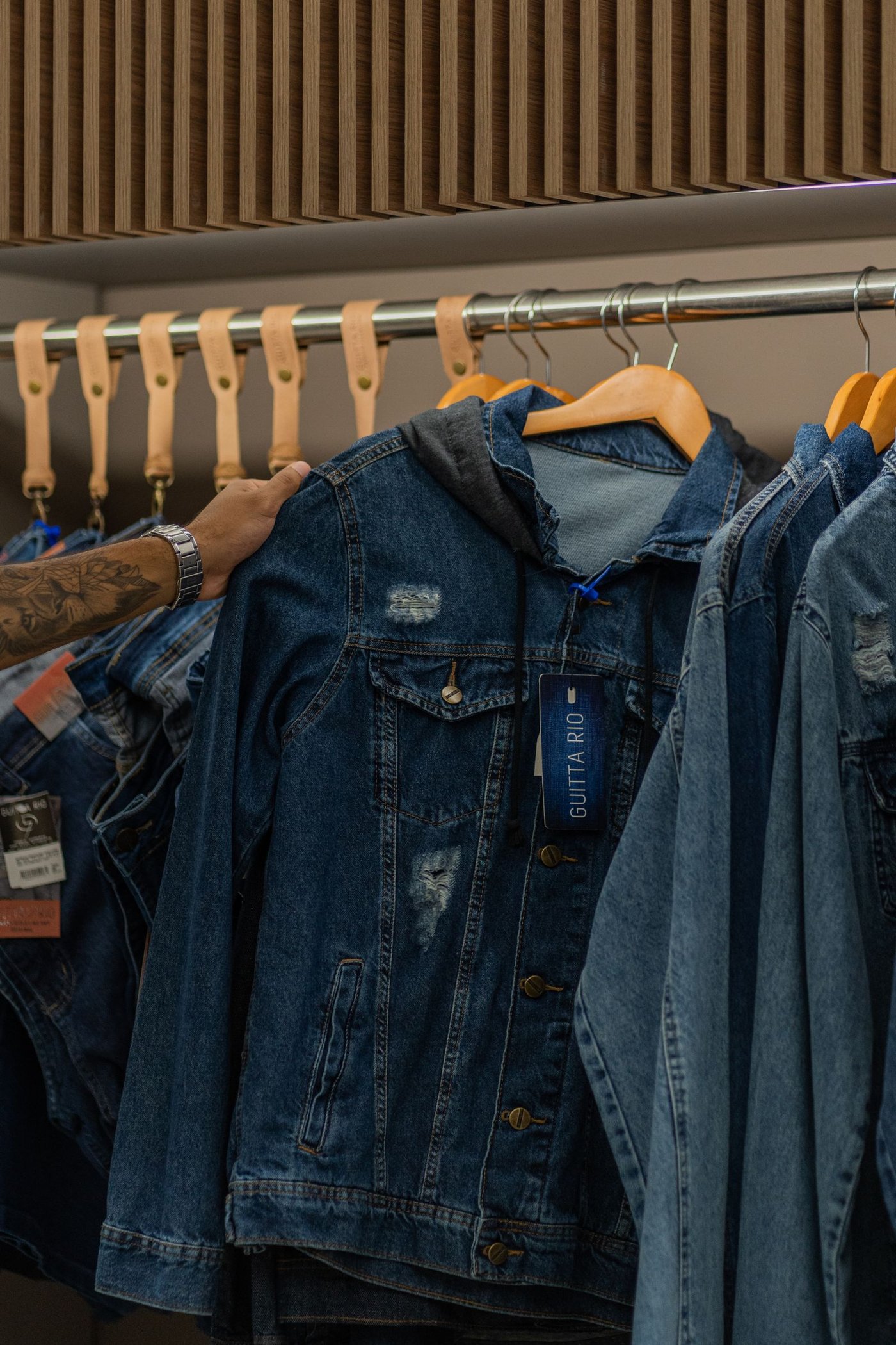 Denim jackets hanging on a rail in a shop