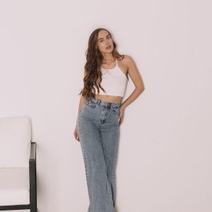 Home Woman in high-waisted blue jeans in a studio