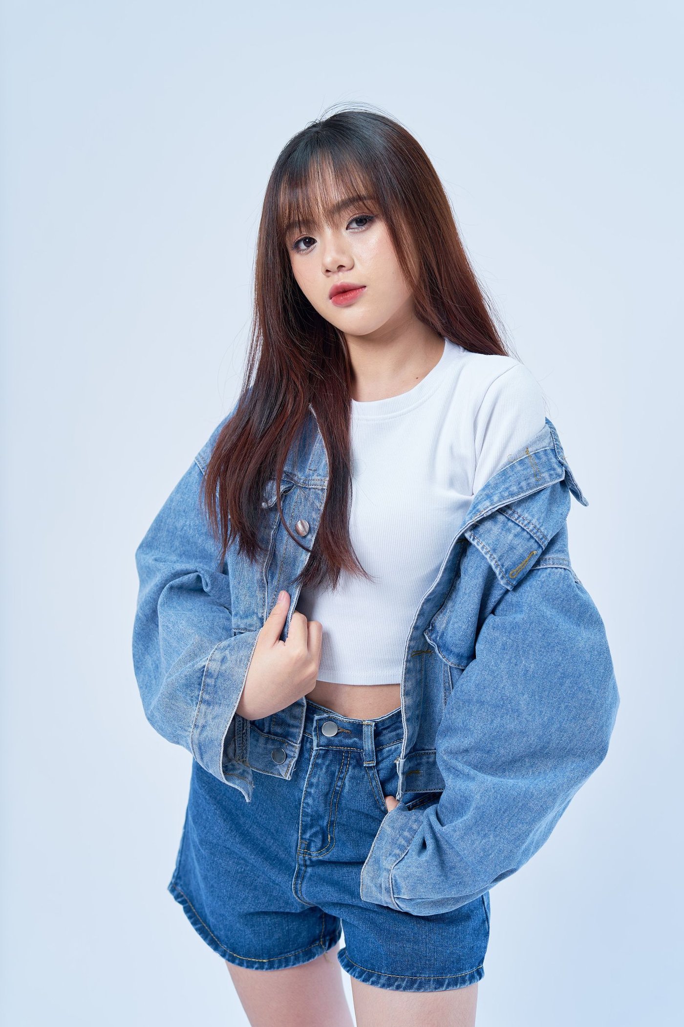 Home Woman in a denim jacket and denim shorts