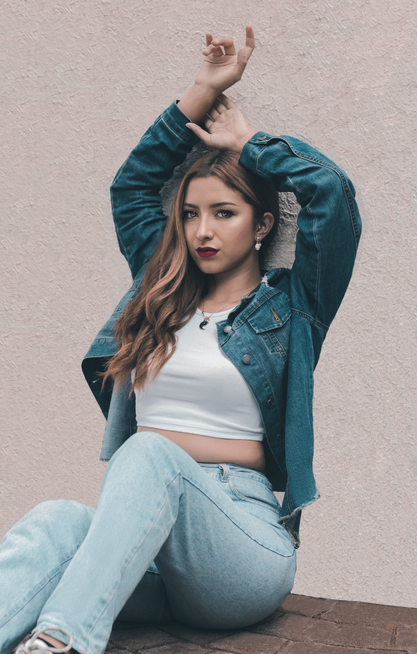 Home Woman in an open denim shirt with arms raised